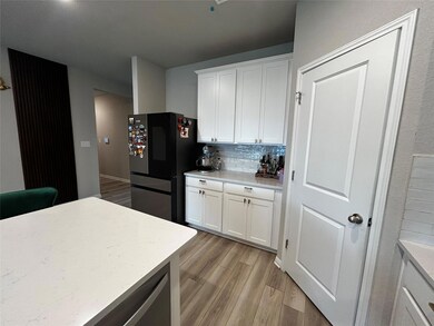 Kitchen with smart refrigerator, light wood finis
