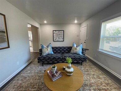 Living room with dark hardwood / wood-style flooring