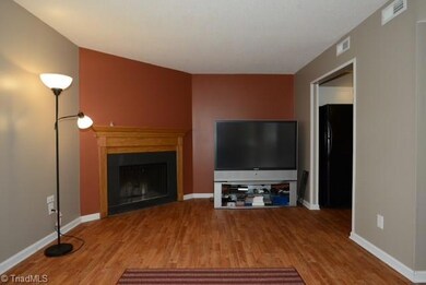 The fireplace and wood grained vinyl give the den a warm and cozy feeling.