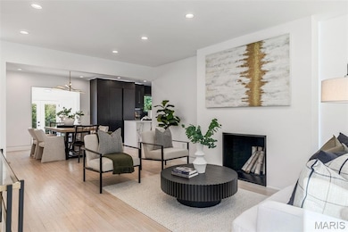 Living area featuring recessed lighting and light wood finished floors