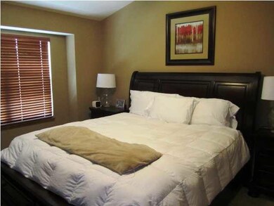 Master bedroom with vautled ceilings and large wal
