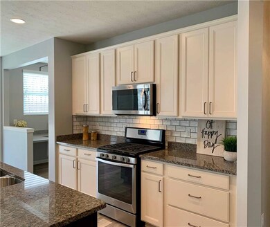 Gas range and subway tile backsplash in this gorgeous kitchen. 