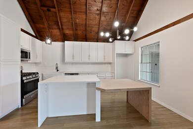 The kitchen offers custom cabinets, a large island