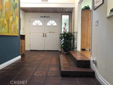 Double-door entry with Spanish pavers