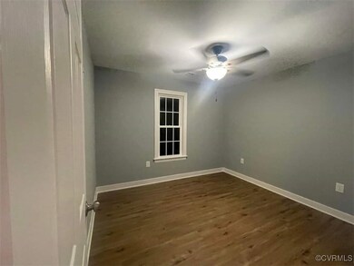 Spare room featuring ceiling fan and dark hardwood / wood-style floors