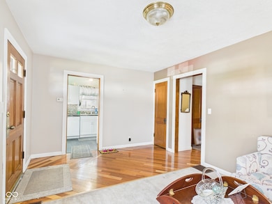 foyer with light wood finished floors and baseboards