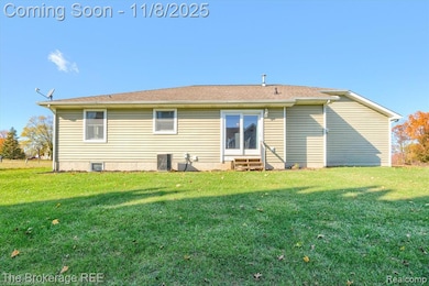 Rear view of property with a yard, roof with shingles, and entry steps