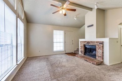 Unfurnished living room featuring a brick fireplac
