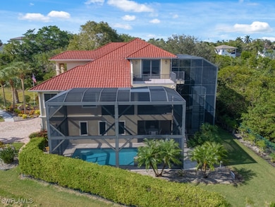 Rear view of house with a balcony, glass enclosure