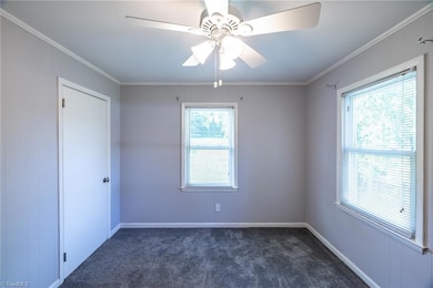 Bedroom 2: Features include carpet flooring to help keep your feet warm on cool mornings, fresh new paint, 2 windows for natural lighting with blinds for privacy, a ceiling fan with light and decorative crown molding. The closet is on the left side.