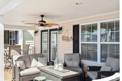 View of patio featuring ceiling fan and outdoor lo
