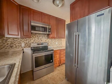 Kitchen featuring light tile patterned floors, sin