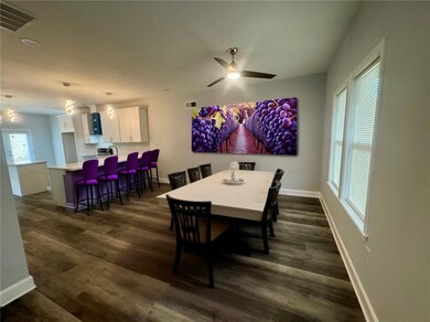 Staged~Diningroom area featuring dark wood-type flooring and ceiling fan