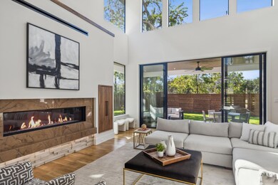 A sleek, modern fireplace is flanked by built in s