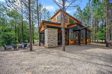 Back of house featuring an outdoor fire pit