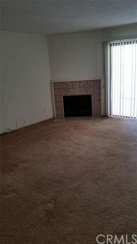Living room with fireplace, sliding doors to patio