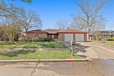 A spacious 2-car garage and wide driveway provide ample parking.