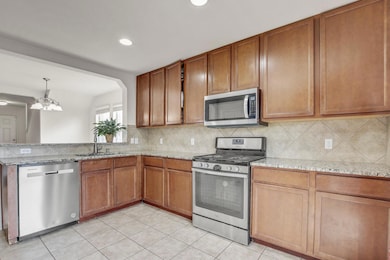 Kitchen featuring stainless steel appliances, bac