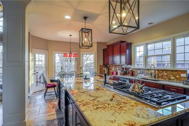Check out this MILLION DOLLAR KITCHEN!!! Enormous granite island, gas range, stone floors and caterer's fridge make this kitchen UNFORGETTABLE. Pictures don't do it justice- must see!! 