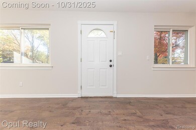 Entryway with dark wood-style flooring and baseboards