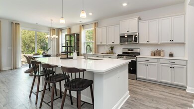Kitchen featuring pendant lighting, an island with