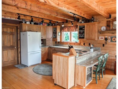 Kitchen has granite countertops and a breakfast ba