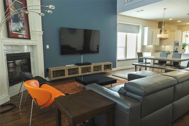 Living room with dark hardwood / wood-style flooring and a fireplace