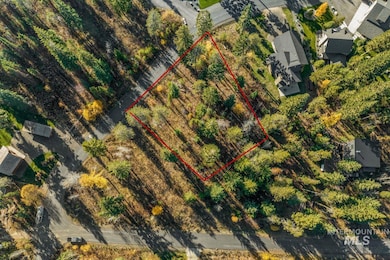 Aerial view of property and surrounding area with property parcel outlined