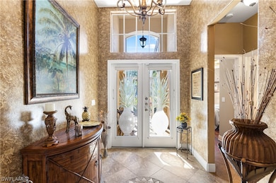 Transom window above doors allows ample light into the home