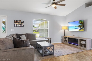 Living room featuring ceiling fan, vaulted ceiling