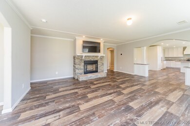 Unfurnished living room featuring wood finished fl