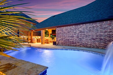 The pool has color changing lights as well as travertine pavers and stone surrounding.