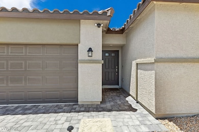 Entrance to property featuring stucco siding, a ti
