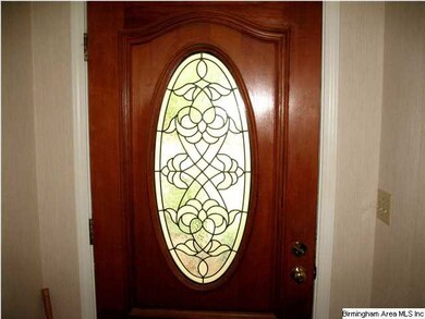 This tasteful solid wood and beveled glass door we