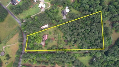 Aerial view of property and surrounding area featuring property parcel outlined