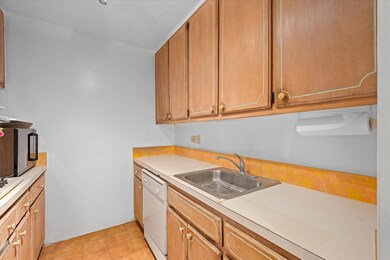 Kitchen with light countertops, dishwasher, and light tile patterned floors