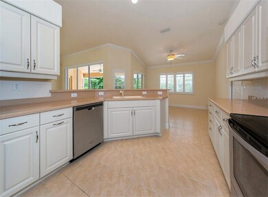 Spacious kitchen with white  cabinets and stainles