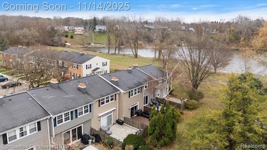 Aerial view of a nearby body of water and a tree filled landscape