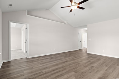 Unfurnished room featuring ceiling fan, wood finis