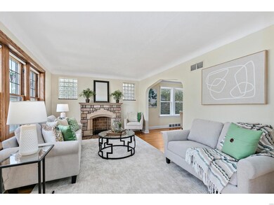 Light filled living room with stone fireplace and glass block windows.