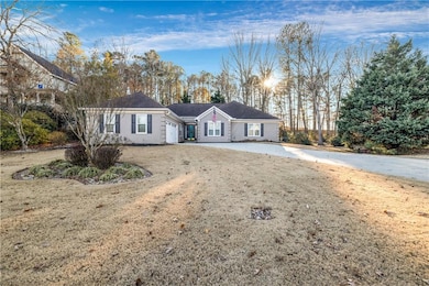 Ranch-style house with an attached garage and concrete driveway