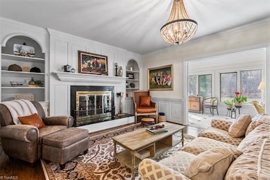 The living room with built-in shelves and fireplace.