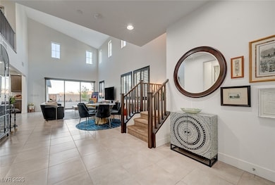 Stairs with high vaulted ceiling, baseboards, and