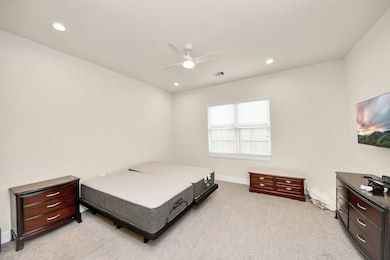 Spacious primary bedroom with ample natural light.