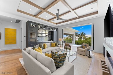 Living area with coffered ceiling, light wood-styl