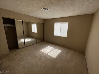 Unfurnished bedroom featuring light carpet, a clos