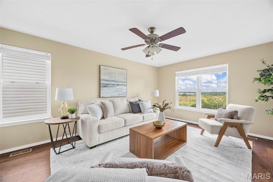 Living area with wood finished floors and a ceiling fan