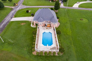 Back aerial view of the property shows the large lot and the gorgeous in-ground pool!