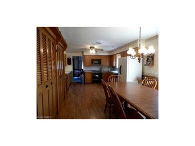 spacious, clean wooden lamented floored kitchen. B