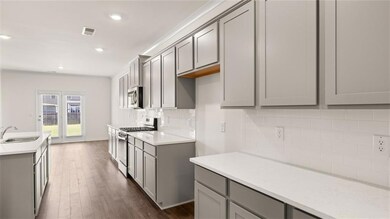 Kitchen featuring visible vents, a sink, gray cabi